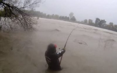 Tough Angler Braves Flood-Swollen River to Catch Catfish