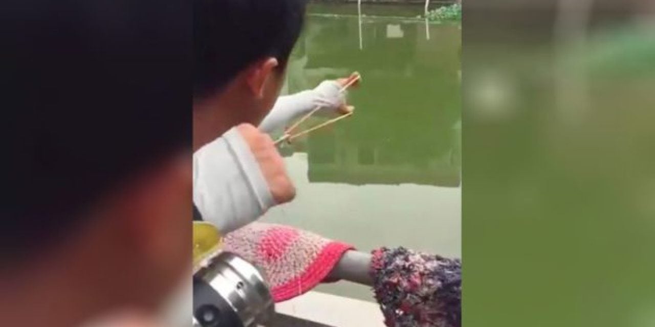 Angler Goes Bowfishing With a Rubber Band and a Reel Strapped to His Arm