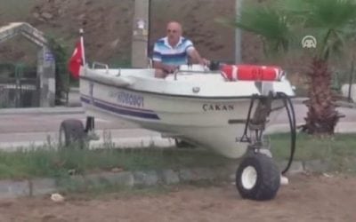 Watch This Guy’s Leisurely Drive Down the Road in His Boat