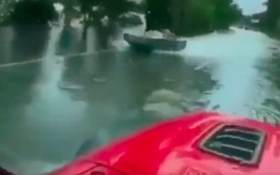 Driver Passes Quick-Moving Jet Boat on a Flooded Highway