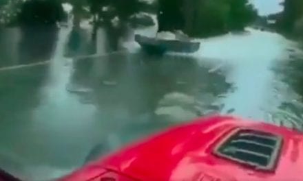 Driver Passes Quick-Moving Jet Boat on a Flooded Highway