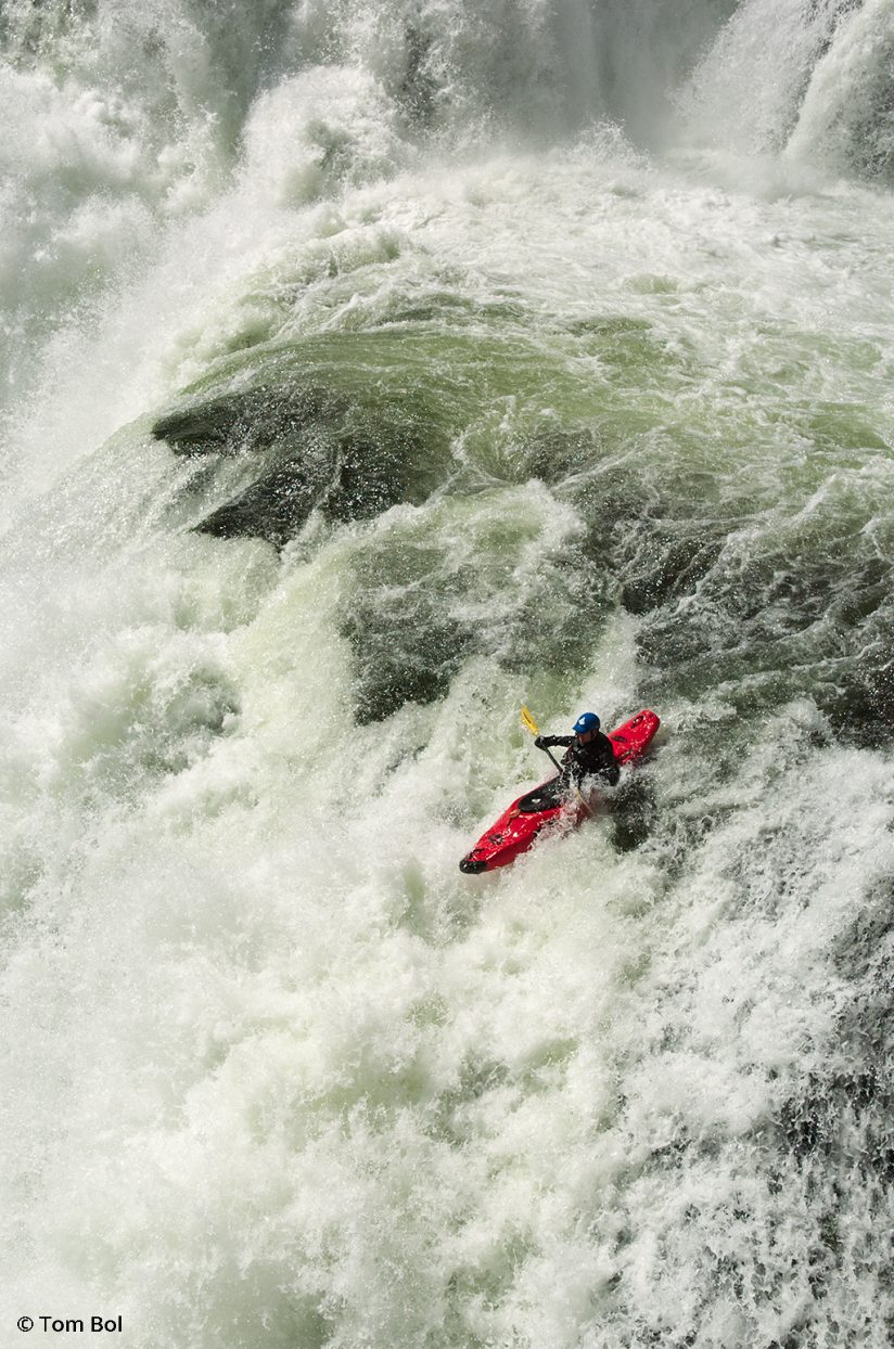 adventure sports photography, image of kayaker descending a waterfall