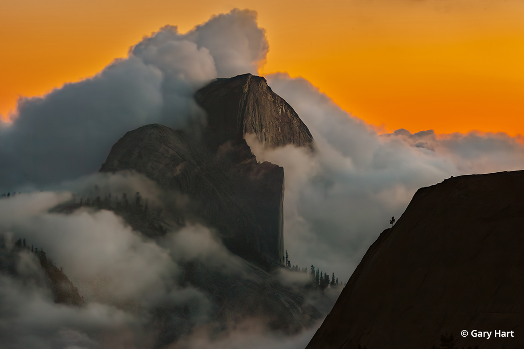 Sunset photo of Half Dome and clouds.