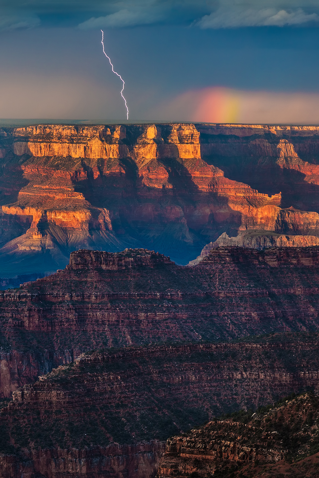 Photo capturing both lightning and a rainbow.