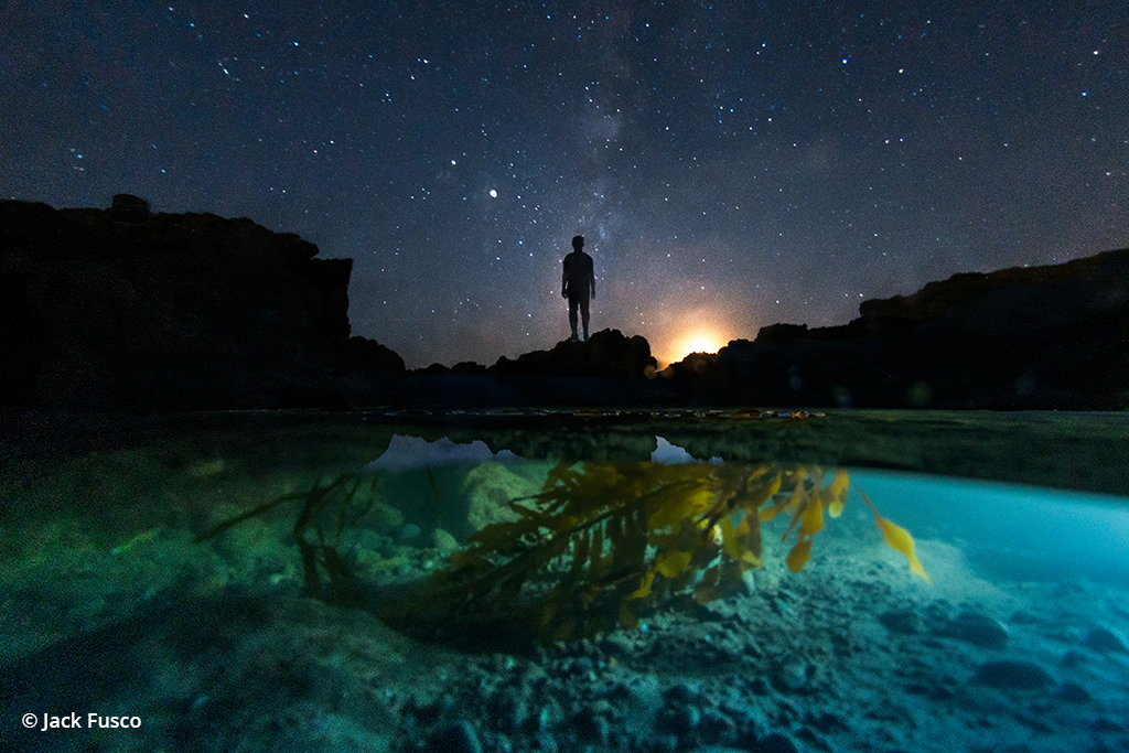 Astrophotography with an underwater scene in the foreground.
