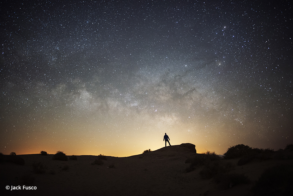 Image of a person in silhouette under the night sky.