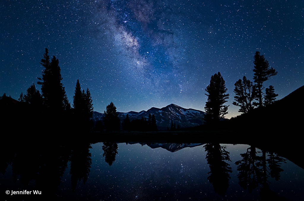 Photograph of stars reflected in a lake at Yosemite.