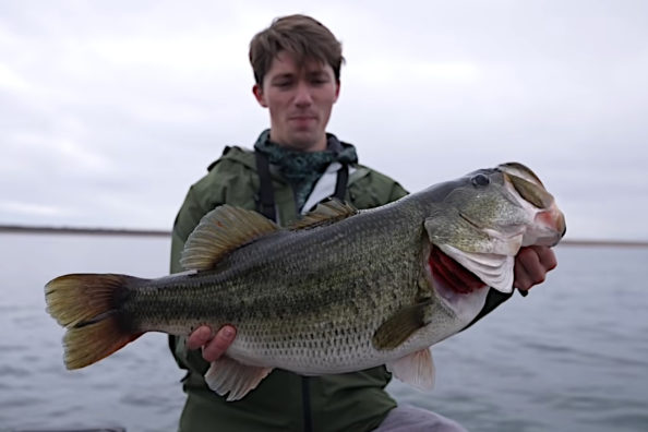 Angler holding a 14-pound largemouth bass.