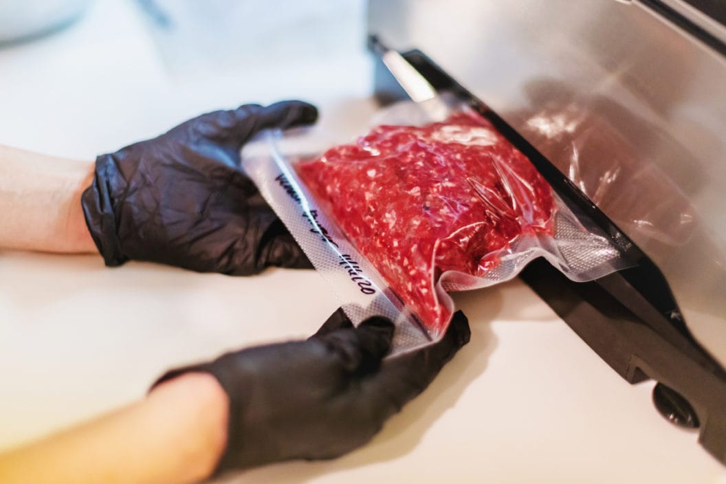 A vacuum sealer being used to preserve ground venison.