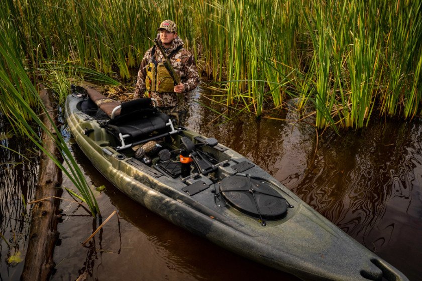 A hunter setting up to hunt from a kayak.