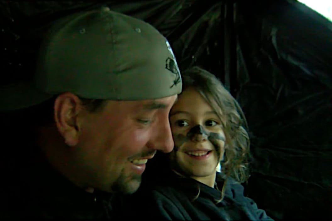 A father and daughter celebrate her shooting her first turkey.