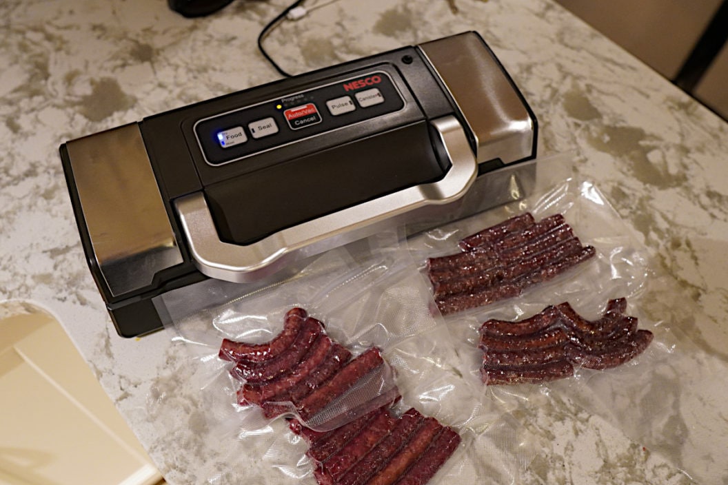 A Nesco Deluxe Vacuum Sealer and several packages of venison.