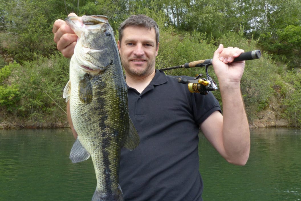 An angler with a large bass caught in the pre-spawn.