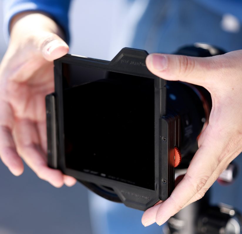 Image of hands adjusting a square filter in its mount