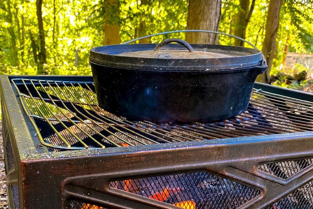 Cast iron Dutch oven cooking on a campfire