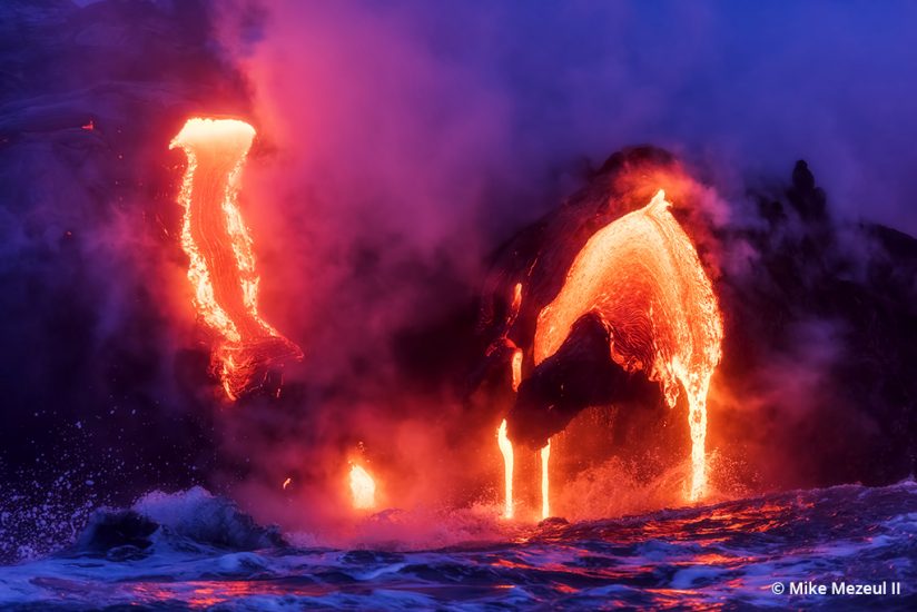 Photo of lava from the Kilauea 61G flow reaching the Pacific Ocean