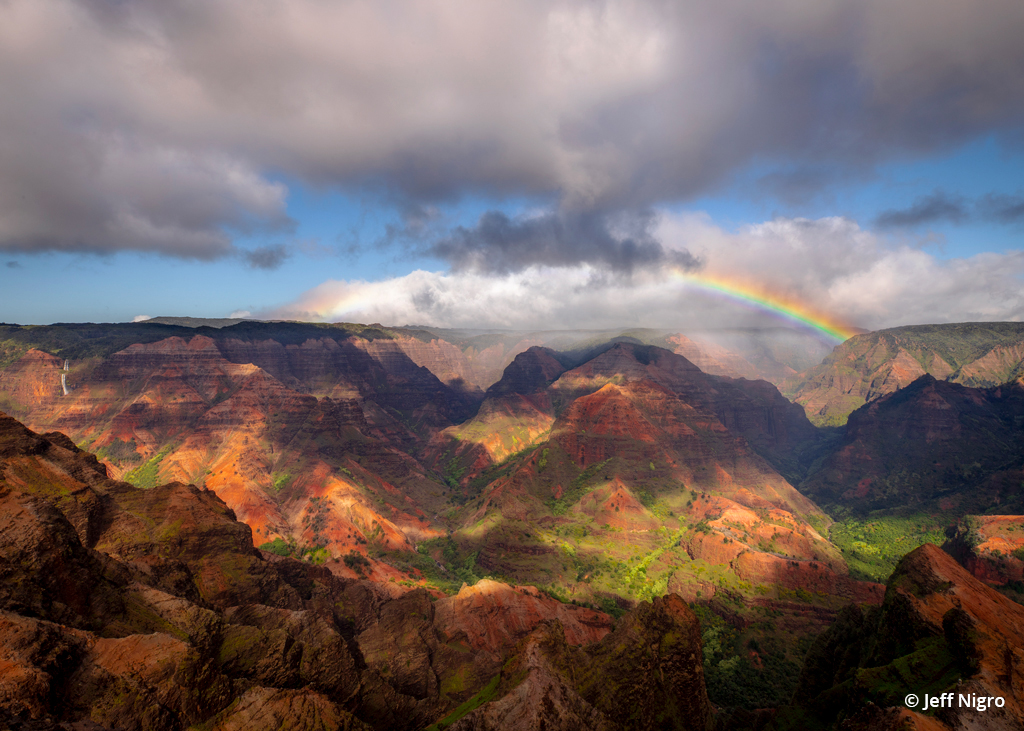 Photo of a rainbow over Waimea Canyon