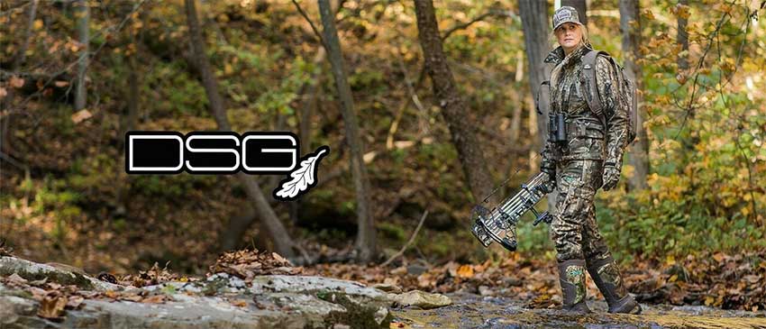 A female hunter in the woods with the DSG apparel company's logo.