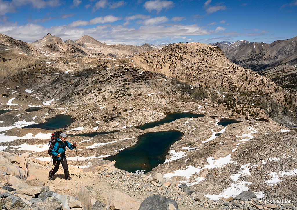 Photographer hiking a trail during a backpacking trip