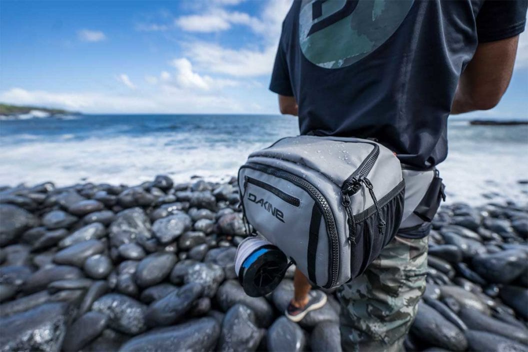 Angler wearing the Dakine Mission Waist Pack while fishing on the coast