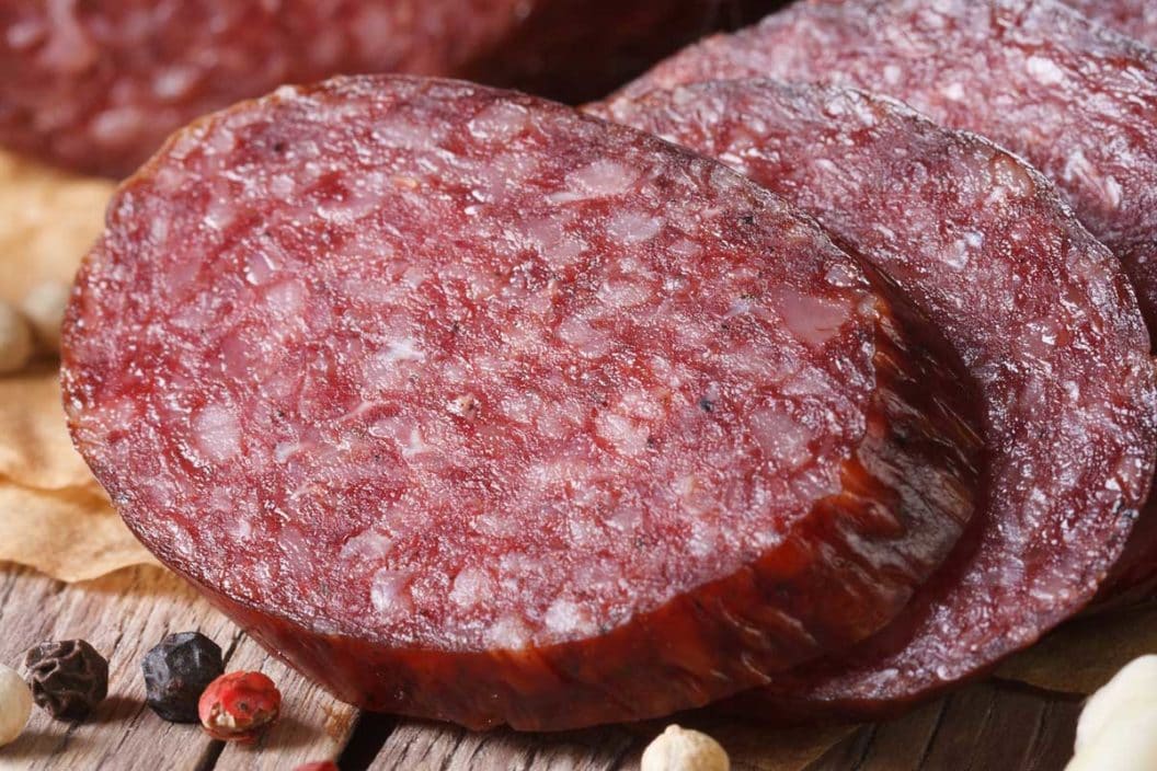 Venison summer sausage on a cutting board