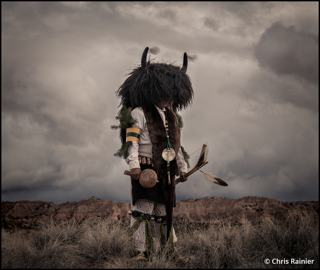 Photo of a Ohkay Owingeh dancer in a bison costume