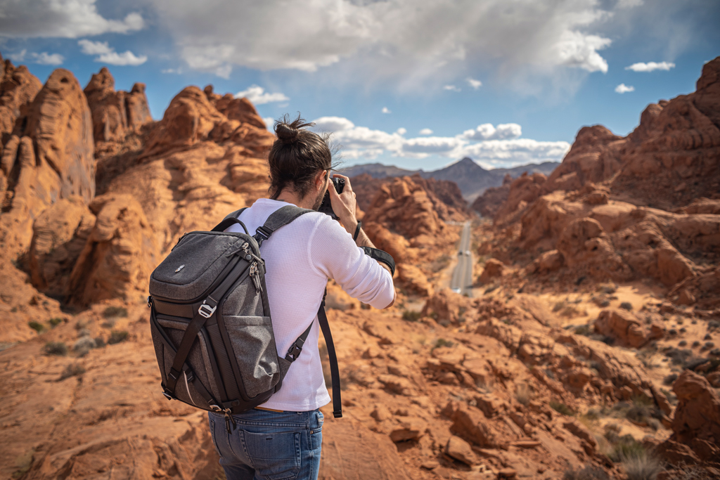 Photo of a photographer wearing the K&F CONCEPT Alpha backpack