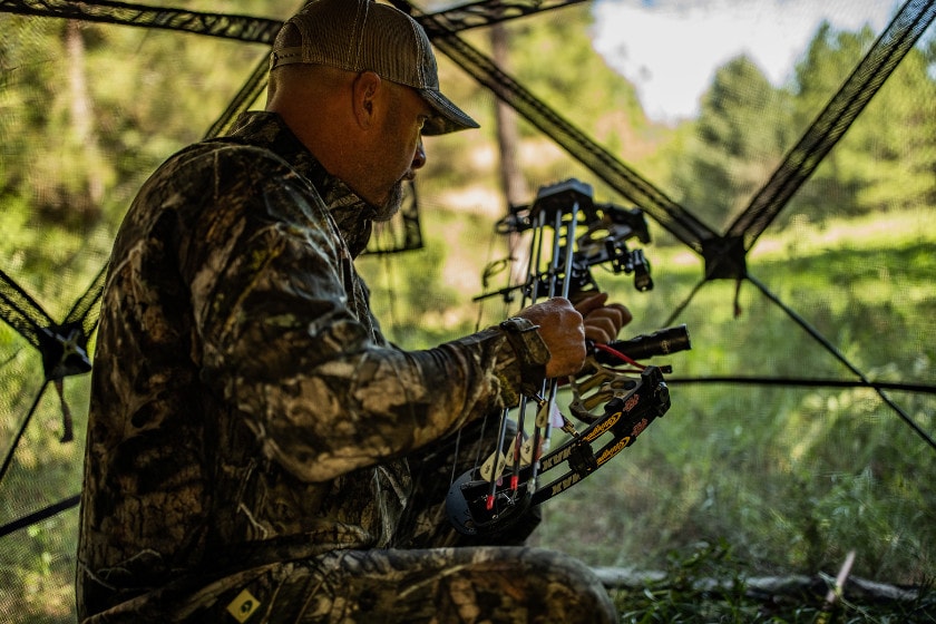 A bowhunter getting ready to knock an arrow.