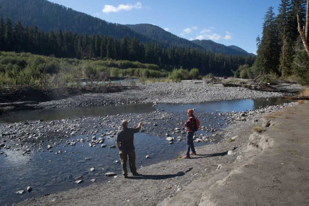 Two men stand near the Hoh River in Olympic National Park