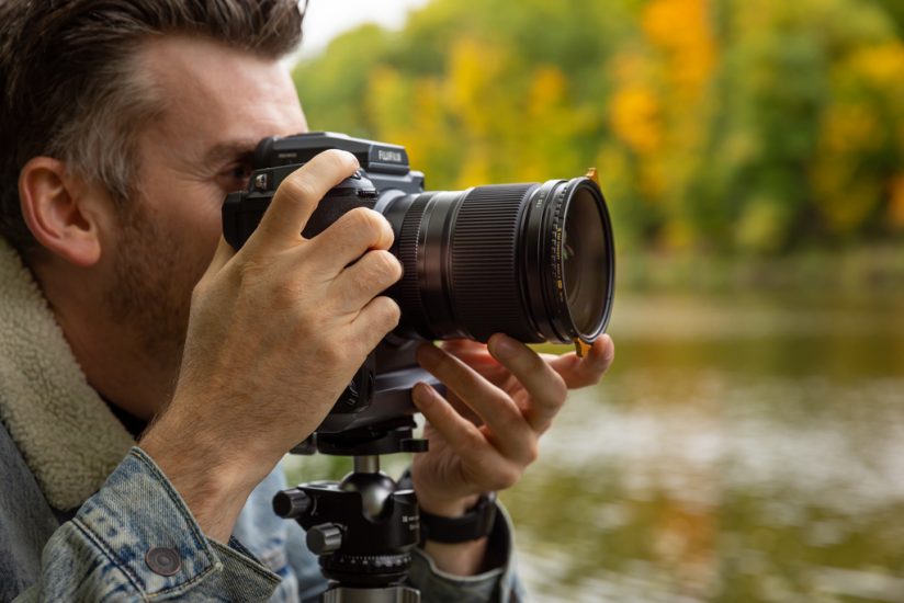 Photo of a photographer using a camera