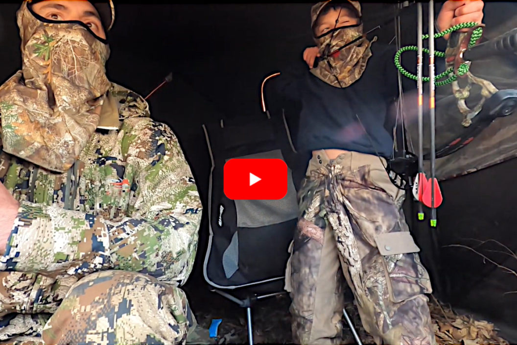 A young bowhunter takes aim at a turkey.