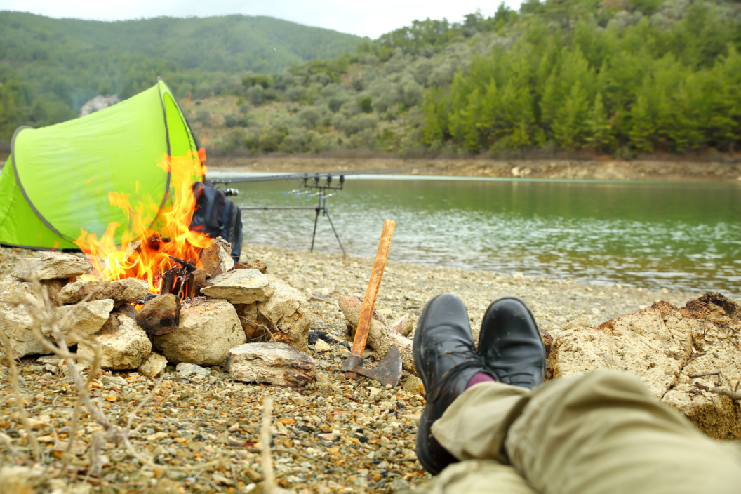 a tent sits next to the water