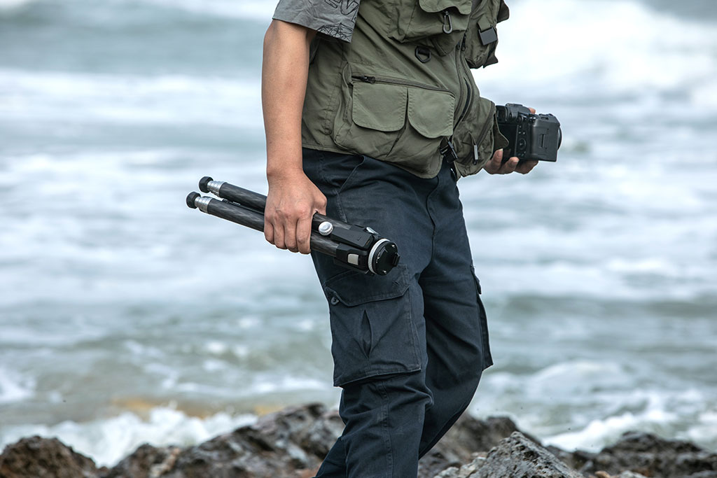 Photo of a person holding a tripod