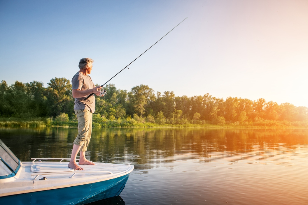 Mature man on a motor boat Fishing in the sun